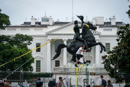 Protesters try to pull down a statue of Andrew Jackson.