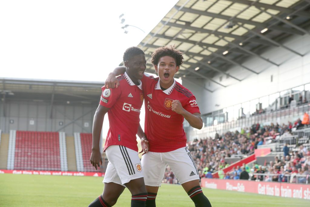 Kobbie Mainoo of Manchester United celebrates scoring a goal to make the score 1-0 with Shola Shoretire (R) during the Premier League 2 match between Manchester United U21 and Brighton &amp; Hove Albion U21 at Leigh Sports Village on October 8, 2022 in Leigh, England.