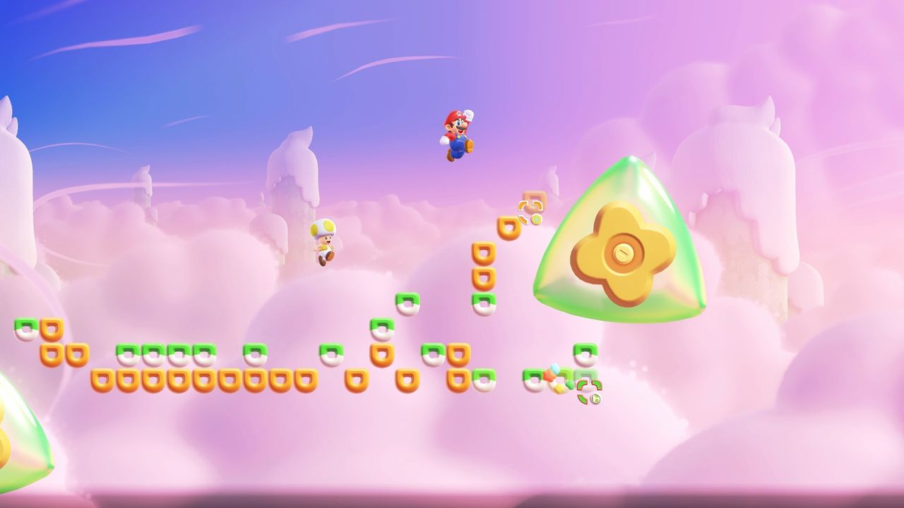 Super Mario Bros Wonder Switch 2 screenshot showing Mario jumping up in the air over small platforms high in the sky towards a flower-shaped block