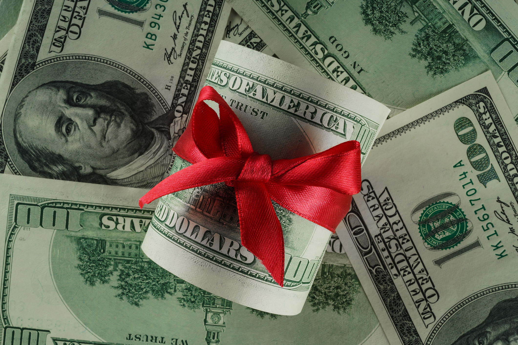 Close up of money with red ribbon