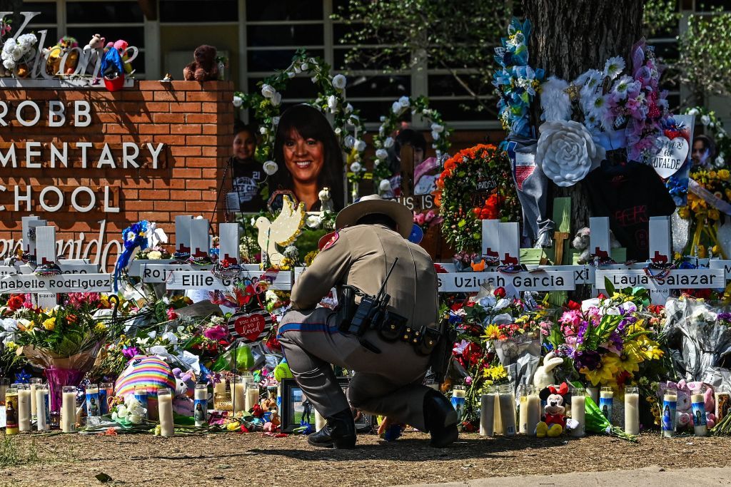 Police officer at Uvalde shooting memorial.