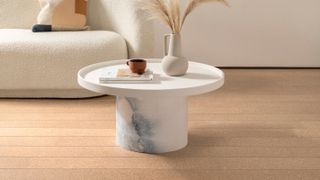 cork flooring in plank format with circular white coffee table