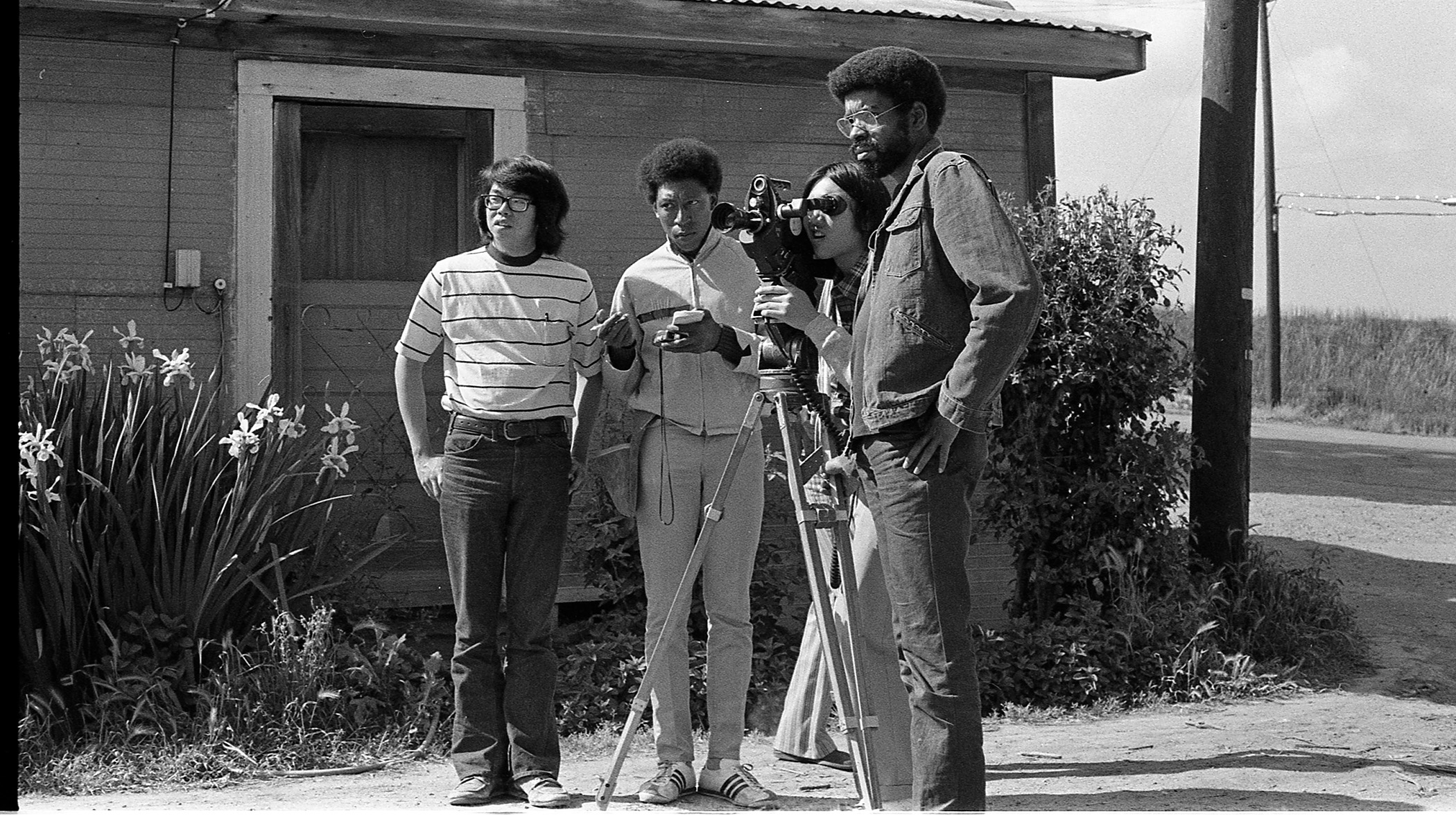 Filmmakers stood around a camera mounted on a tripod. 