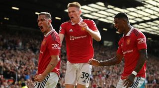 Antony, Scott McTominay and Marcus Rashford celebrate a goal in Manchester United's win over Arsenal.