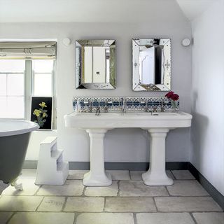 white bathroom with grey bathtub and washbasin
