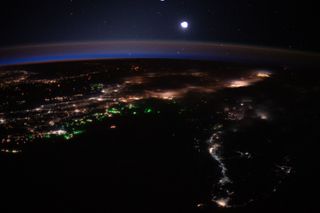 City lights of Malaysia and Indonesia light up the Earth beneath a blanket of blue and orange airglow while boat lights glow in the Bay of Bengal in this nighttime view of Earth from space. An Expedition 62 astronaut captured this photo from the International Space Station on March 21, when the space station was orbiting 262 miles (422 kilometers) overhead.