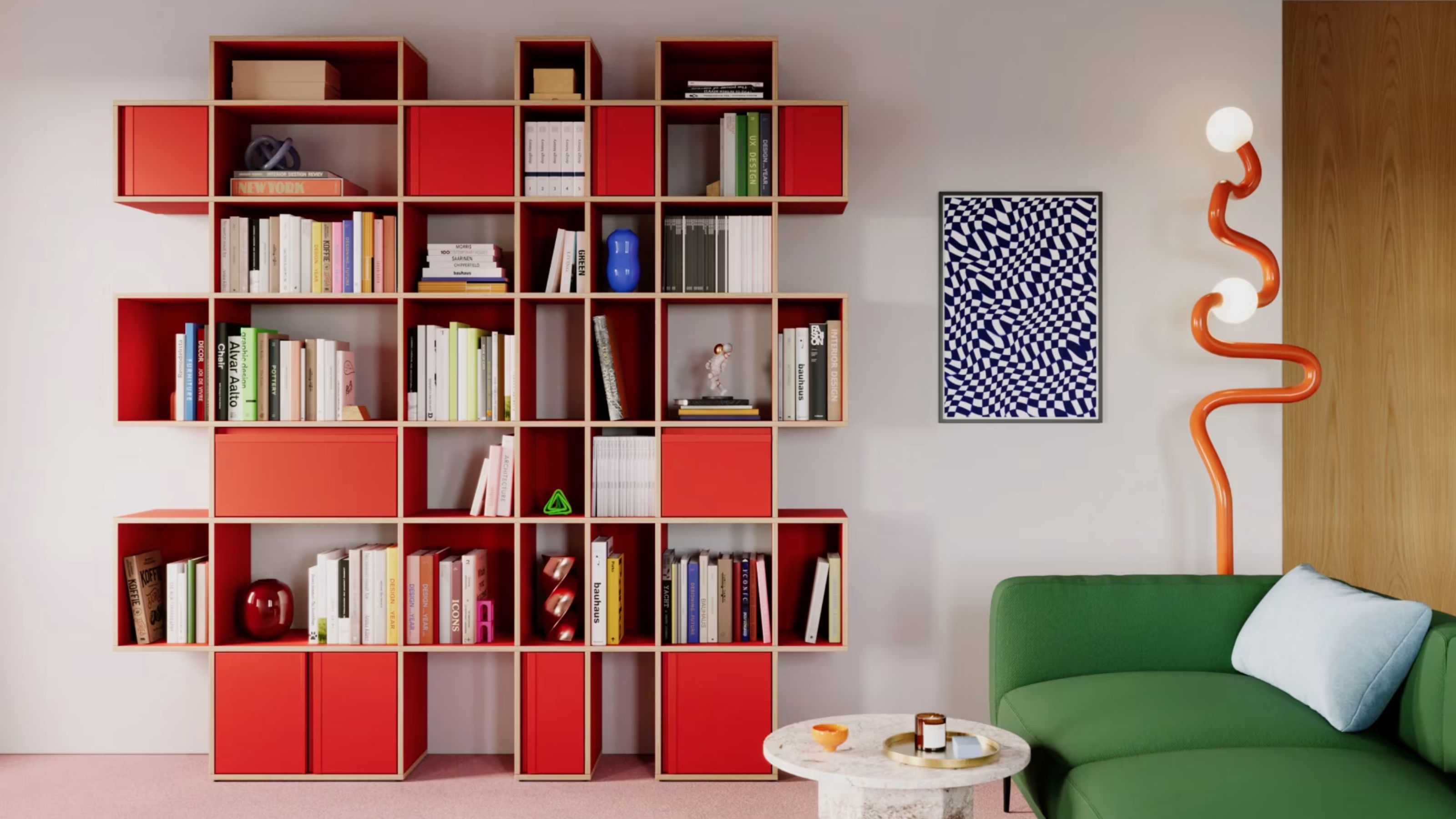 modular red shelving unit with cubes, some open and some closed, filled with books, next to an artwork and curvy floor lamp, green sofa with a blue pillow and round side table