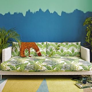 living room with tropical theme and palm print sofa