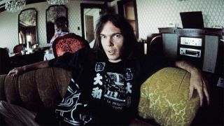 Neil Young posed at a hotel in Tokyo, 1976