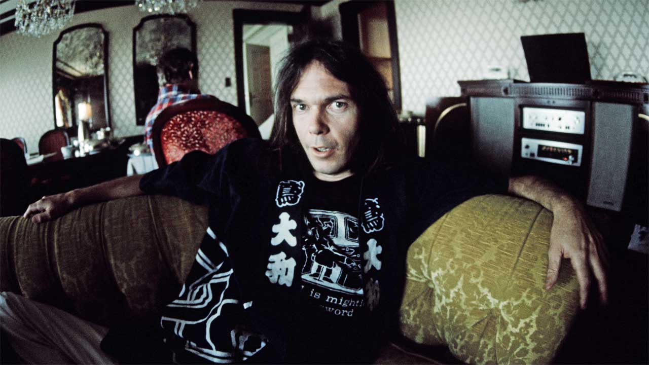 Neil Young posed at a hotel in Tokyo, 1976