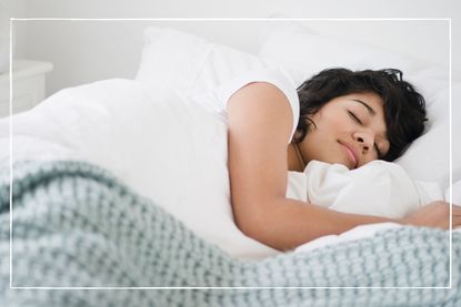 Dreaming about being pregnant Woman sleeping in white bed 