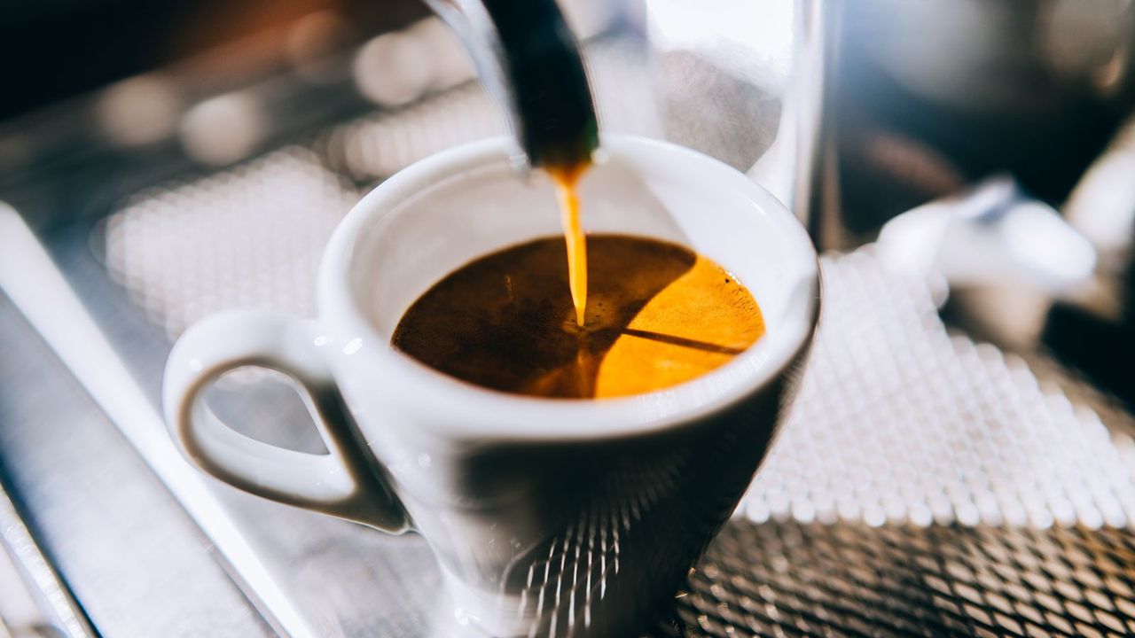 How to make espresso: an espresso being pulled from an espresso machine