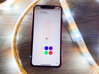How to use Adaptive Lighting with your HomeKit-enabled lights. iPhone 11 with Adaptive Lighting on display inside of an Eve Light Strip.