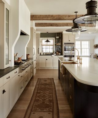 Neutral kitchen with a runner and statement range hood