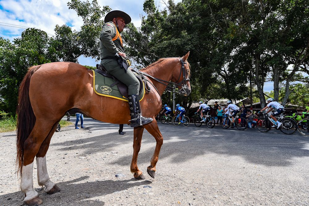 A local watches the peloton pass by at Colombia Oro y Paz