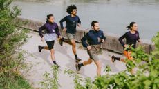 best running shoes: a group of runners running on a river bank wearing ASICS running gear