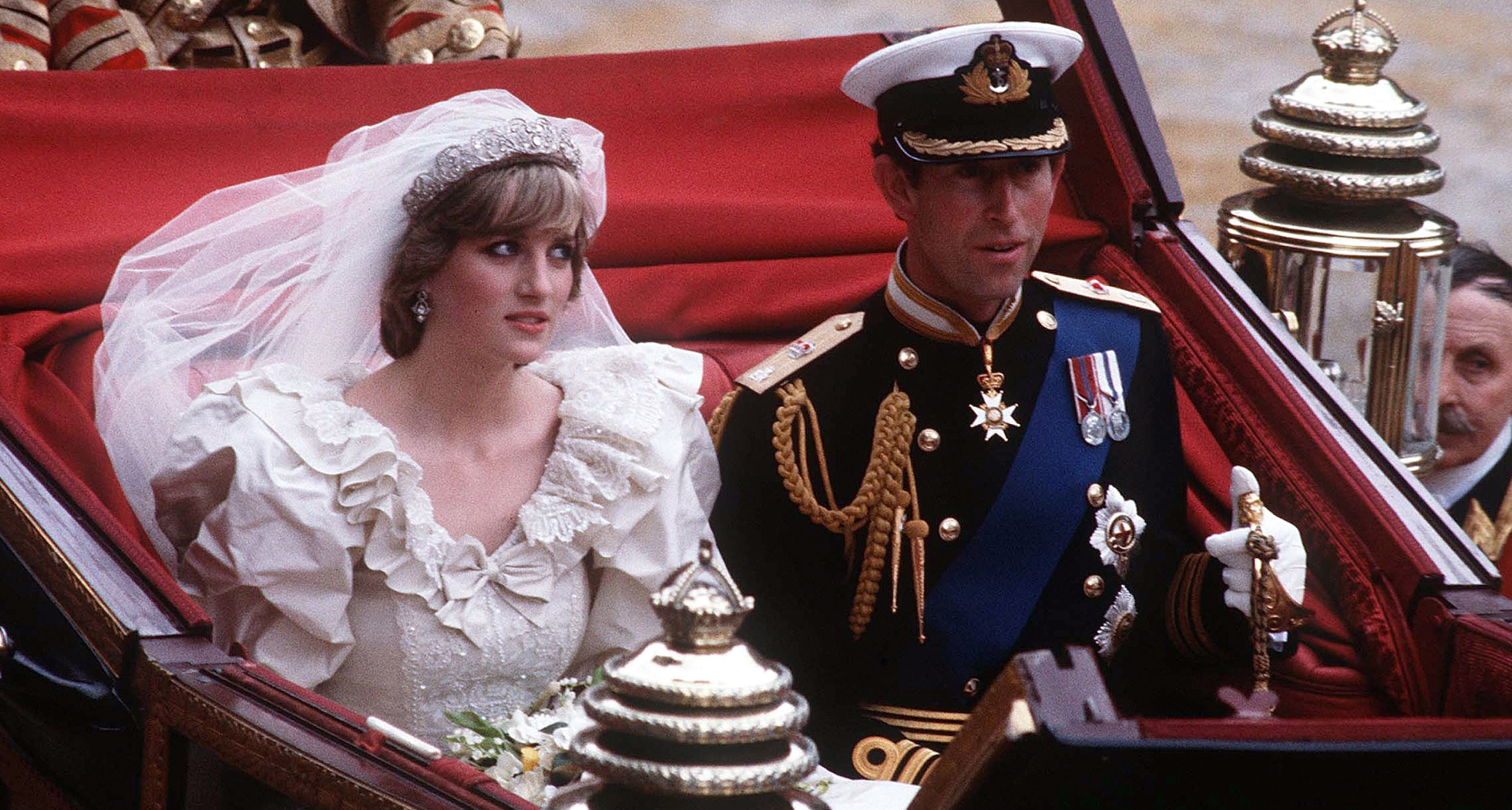 Prince Charles and Princess Diana riding in a carriage on their wedding day