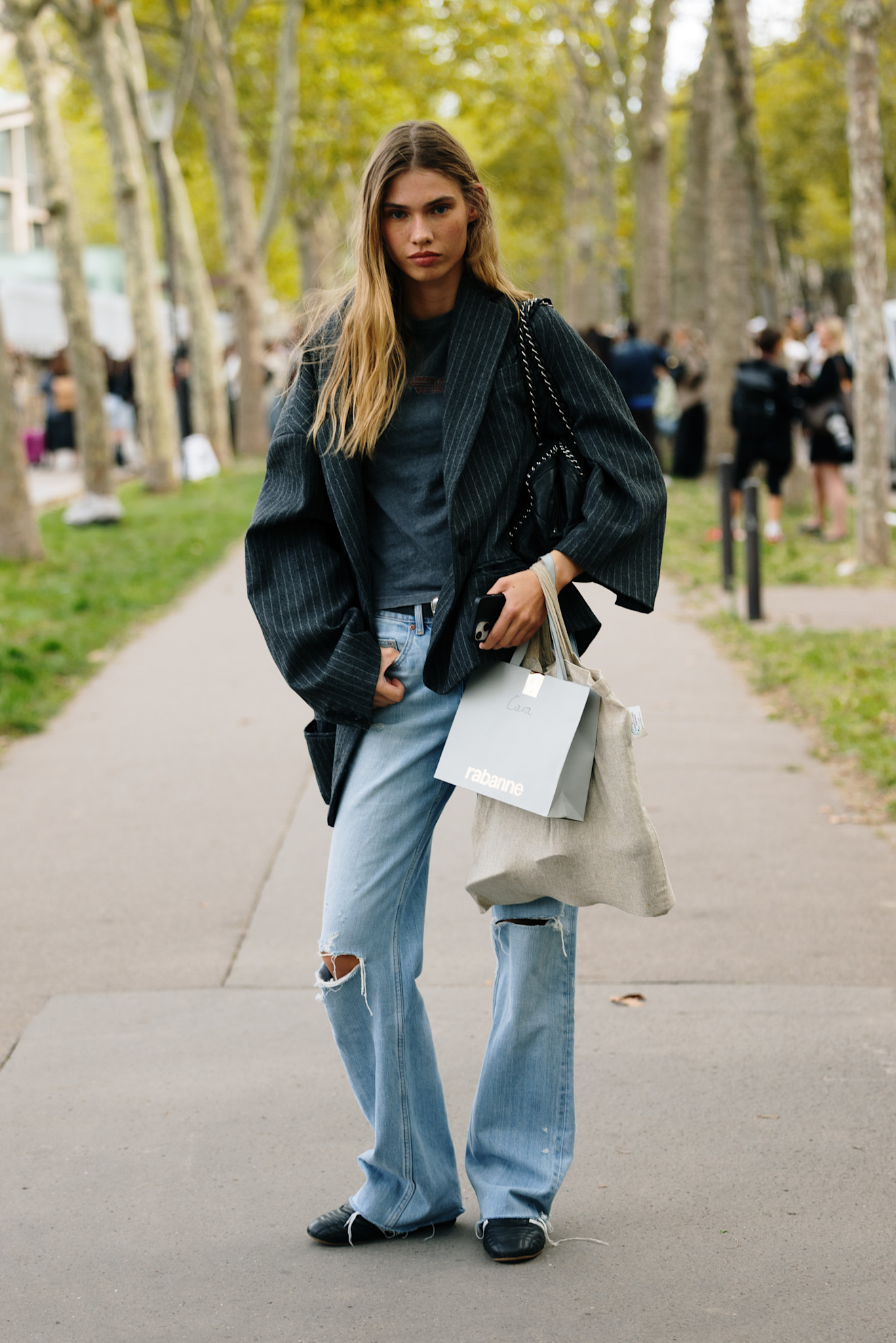 BERLIN, GERMANY - NOVEMBER 07: Sophia Geiss with brown hair seen wearing black Jil Sander shoes, light blue Acne Studios wide jeans, and a beige oversized fur jacket from The Frankie Shop, styled with a brown Zadig & Voltaire bag and brown Mango sunglasses on November 07, 2025 in Berlin, Germany. (Photo by Jeremy Moeller/Getty Images)