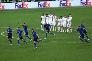 Players of Italy celebrate following victory in the penalty shoot out as players of England look dejected during the UEFA Euro 2020 Championship Final between Italy and England at Wembley Stadium on July 11, 2021 in London, England. (Photo by Ryan Pierse - UEFA/UEFA via Getty Images)