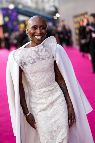 Cynthia Erivo wears a structural white lace gown on the red carpet of the BAFTAs 2025