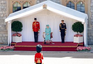 WINDSOR, UNITED KINGDOM - JUNE 13: (EMBARGOED FOR PUBLICATION IN UK NEWSPAPERS UNTIL 24 HOURS AFTER CREATE DATE AND TIME) Queen Elizabeth II, accompanied by Lieutenant Colonel Michael Vernon (Comptroller of the Lord Chamberlain's Office) (L) and Vice Admiral Tony Johnstone-Burt (Master of the Household) (R), attends a military ceremony in the Quadrangle of Windsor Castle to mark her Official Birthday on June 13, 2020 in Windsor, England. It was decided that due to the ongoing COVID-19 Pandemic The Queen's Birthday Parade, known as Trooping the Colour, would not go ahead in it's traditional form at Buckingham Palace and Horse Guards Parade, but a small military ceremony in line with the Government's Social Distancing Guidelines would take place at Windsor Castle instead. Soldiers of 1st Battalion Welsh Guards (whose Colour was due to be Trooped this year) will carry out a series of military drills and Royal Salute. (Photo by Max Mumby/Indigo/Getty Images)