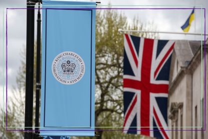 a close up of a blue King Charles coronation flag and a Union Jack flag in London ahead of the coronation