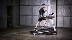 Person running on the Reebok Jet 100 Series Bluetooth Treadmill