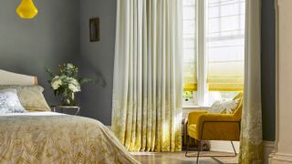 white and yellow full length curtains in grey master bedroom