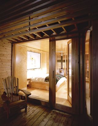 Bedroom of Sunset cabin through glass window
