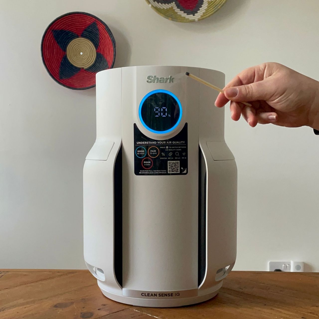 Lighting and blowing out a match in front of the Shark NeverChange 5 Air Purifier