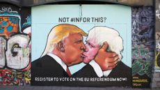 A mural on a derelict building in Bristol shows Donald Trump sharing a kiss with prominent Brexiter Boris Johnson