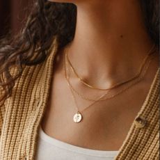 Woman wearing GLDN necklace