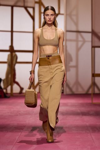 Hermès model at the S/S 25 runway show in Paris wearing a camel-colored monochrome look.