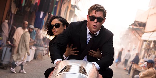 Chris Hemsworth and Tessa Thompson riding a hovercycle in Men in Black: International