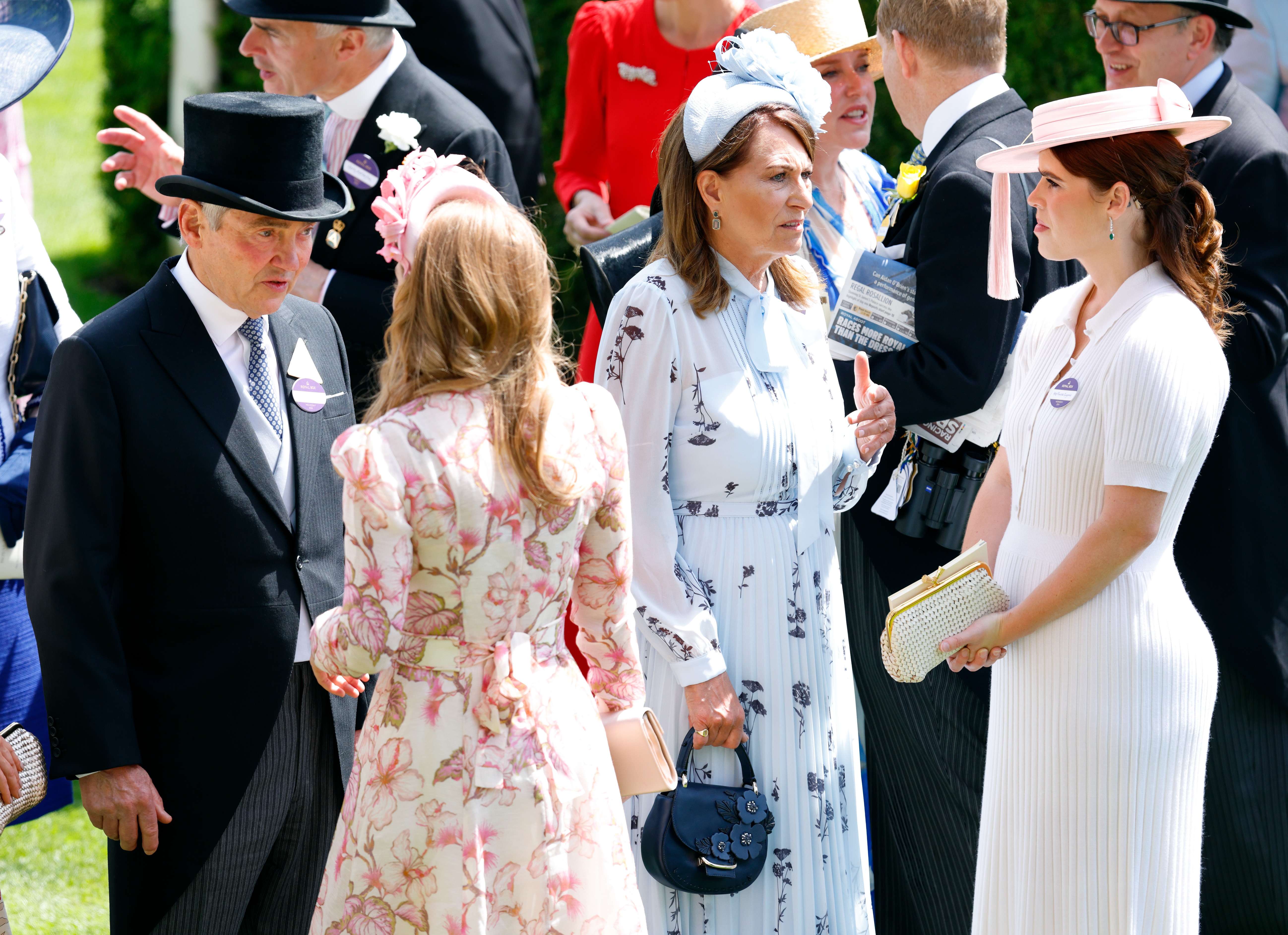 Princess Eugenie and Princess Beatrice talking to Carole and Michael Middleton