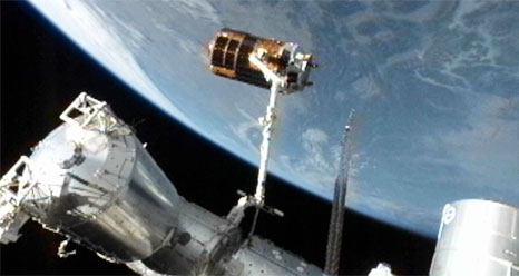 Japan&#039;s unmanned HTV-3 cargo ship is perched at the end of the International Space Station&#039;s robotic arm before its release on Sept. 12, 2012