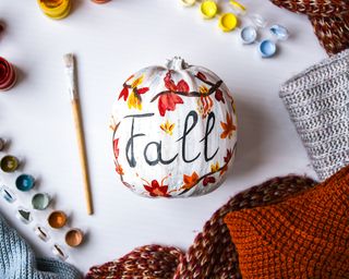 pumpkin painted with Fall message