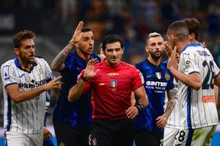 Inter's and Atalanta's player argue with Italian referee Fabio Maresca (C) during the Italian Serie A football match between Inter Milan and Atalanta Bergamo at the San Siro stadium in Milan, on September 25, 2021.