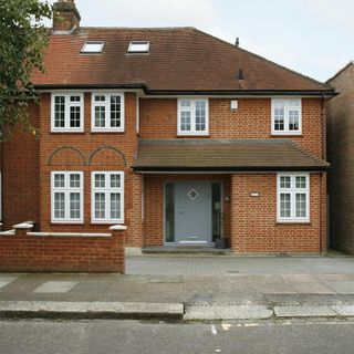 house with brick walls and sash windows