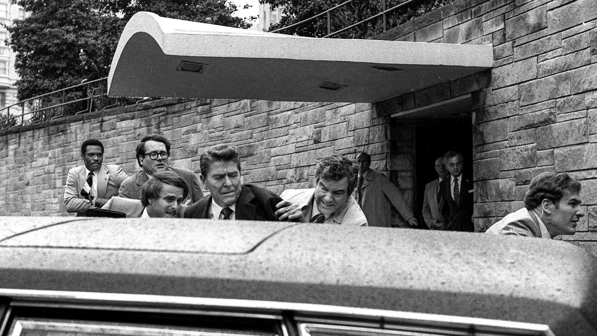 In this March 30, 1981 file photo, U.S. President Ronald Reagan, center, is shown being shoved into the President&#039;s limousine by secret service agents after being shot outside a Washington hotel. The man who shot Reagan is scheduled to leave a Washington mental hospital for good on Saturday, Sept. 10, 2016, more than 35 years after the shooting. A federal judge ruled in late July that the 61-year-old John Hinckley Jr. is not a danger to himself or the public and can live full-time at his mother&#039;s home in Williamsburg, Virginia. (AP Photo/Ron Edmonds, File)