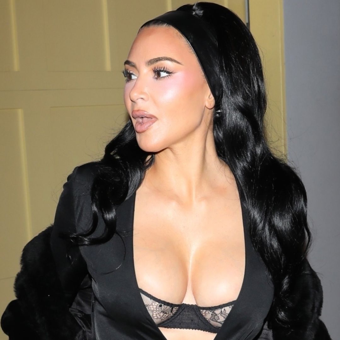 Kim Kardashian attended a holiday party wearing a peekaboo bra, a plunging maxi dress, and a matching fur
