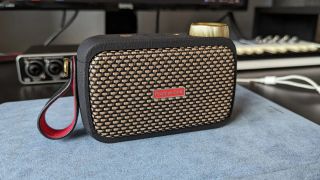 A Positive Grid Spark Go mini amp on a studio desk