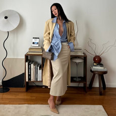 Influencer Caroline Lin wearing a butter yellow coar and sky blue shirt. 