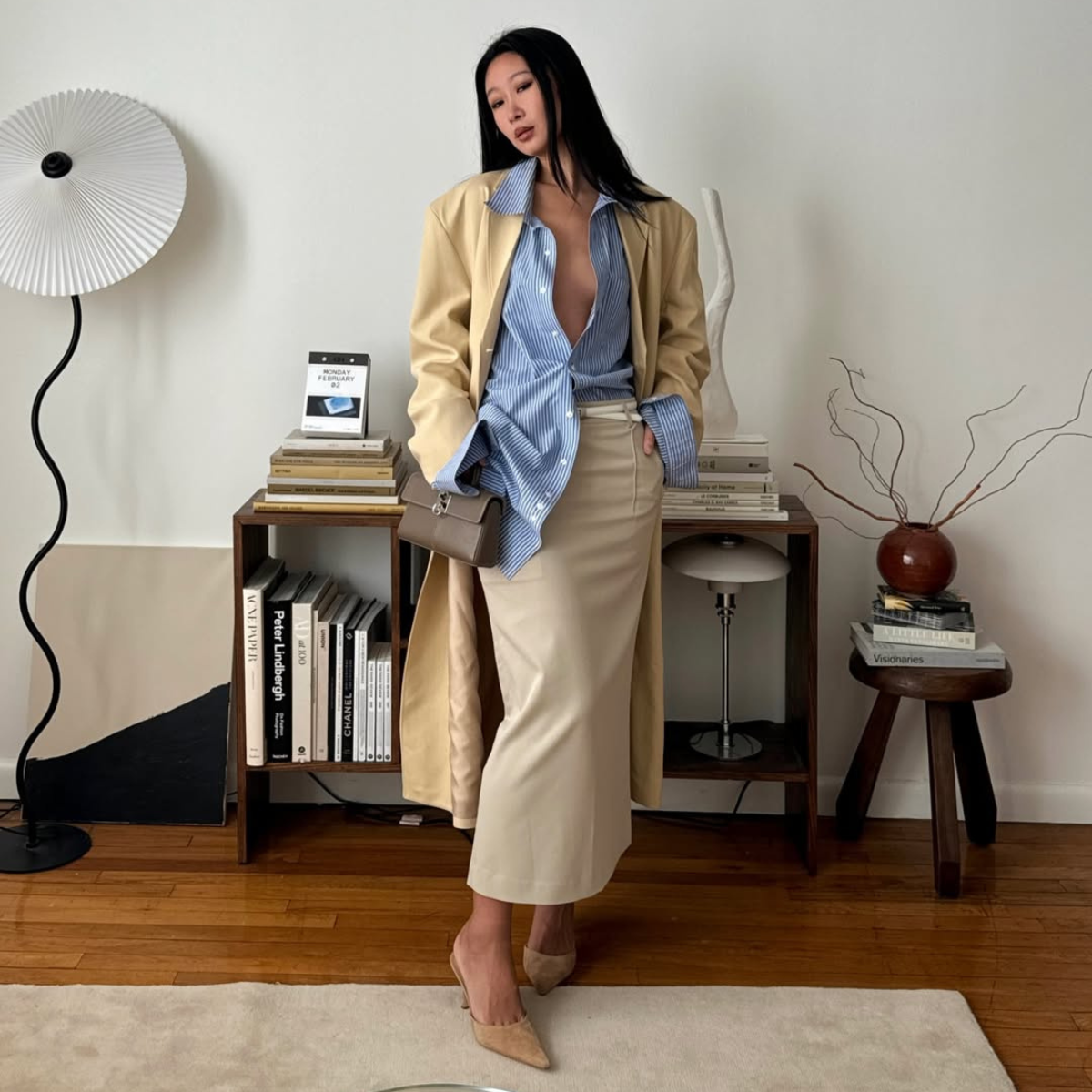 Influencer Caroline Lin wearing a butter yellow coar and sky blue shirt. 