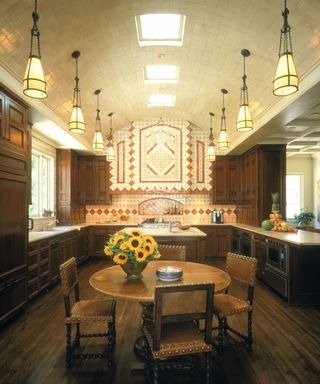 A grand kitchen with dark wood cabinetry and a tiled colorful range hood
