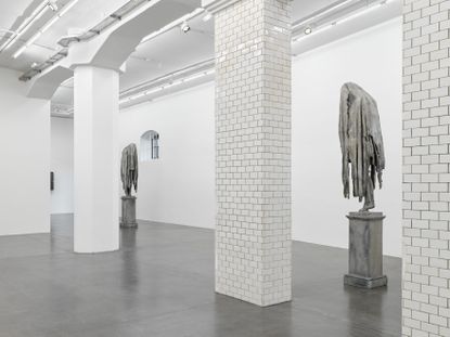 two sculptures of human figures with blankets over their headsview of sculptures at hauser & wirth for berlinde de bruyckeres show 