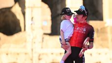 Geraint Thomas holding his son on the podium of the giro d'italia in May 2024 