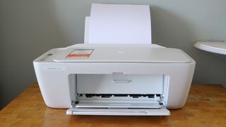 A photograph of the HP Deskjet 2710e on a desk