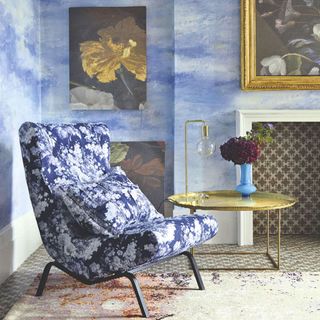 blue wall with floral painting blue floral designed chair and floral cushion
