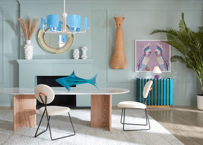 blue pendant lighting over a modern dining table in a green living room